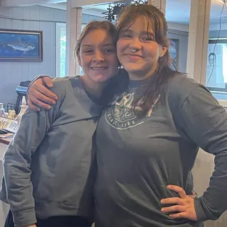 Two smiling team members in the dining room at The Point Restaurant Perdido